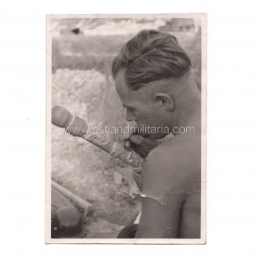 Photo of a German soldier carving Wolchow stick Germany 1933–1945